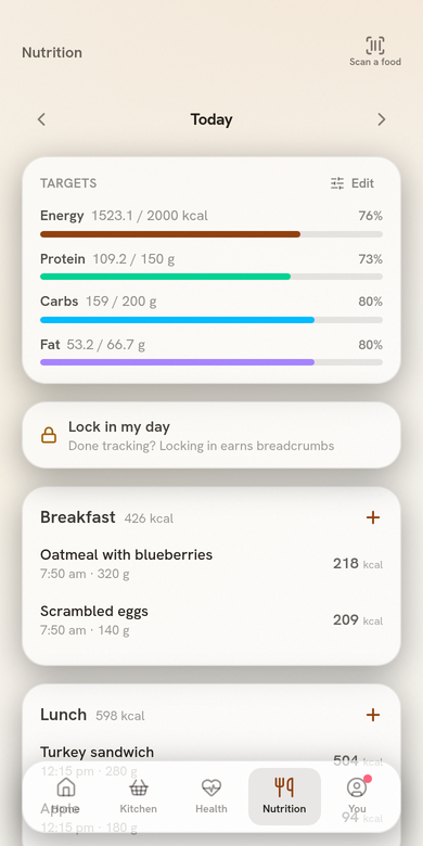 Nutrition tab in light mode: daily energy and macro targets with calories earned from workouts, and logged meals